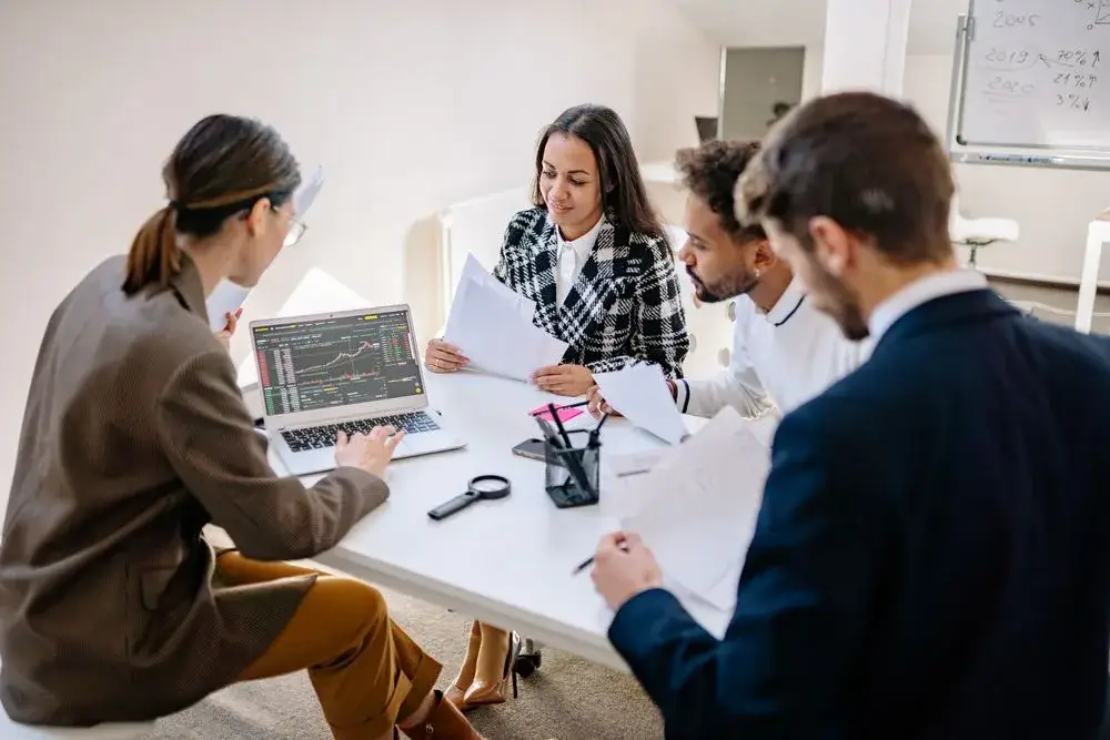 Colleagues discussing a presentation around a table